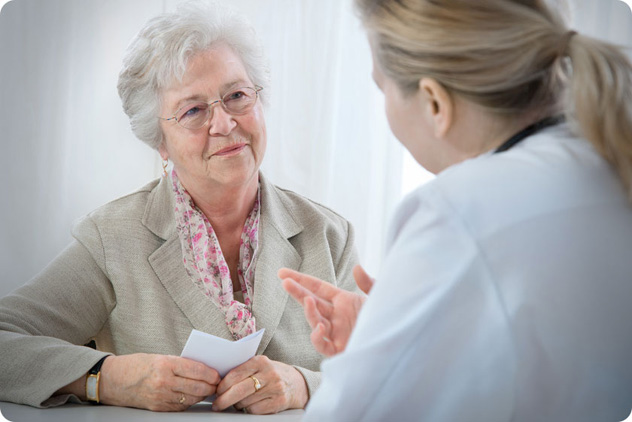 Пожилая женщина консультируется на приеме у врача